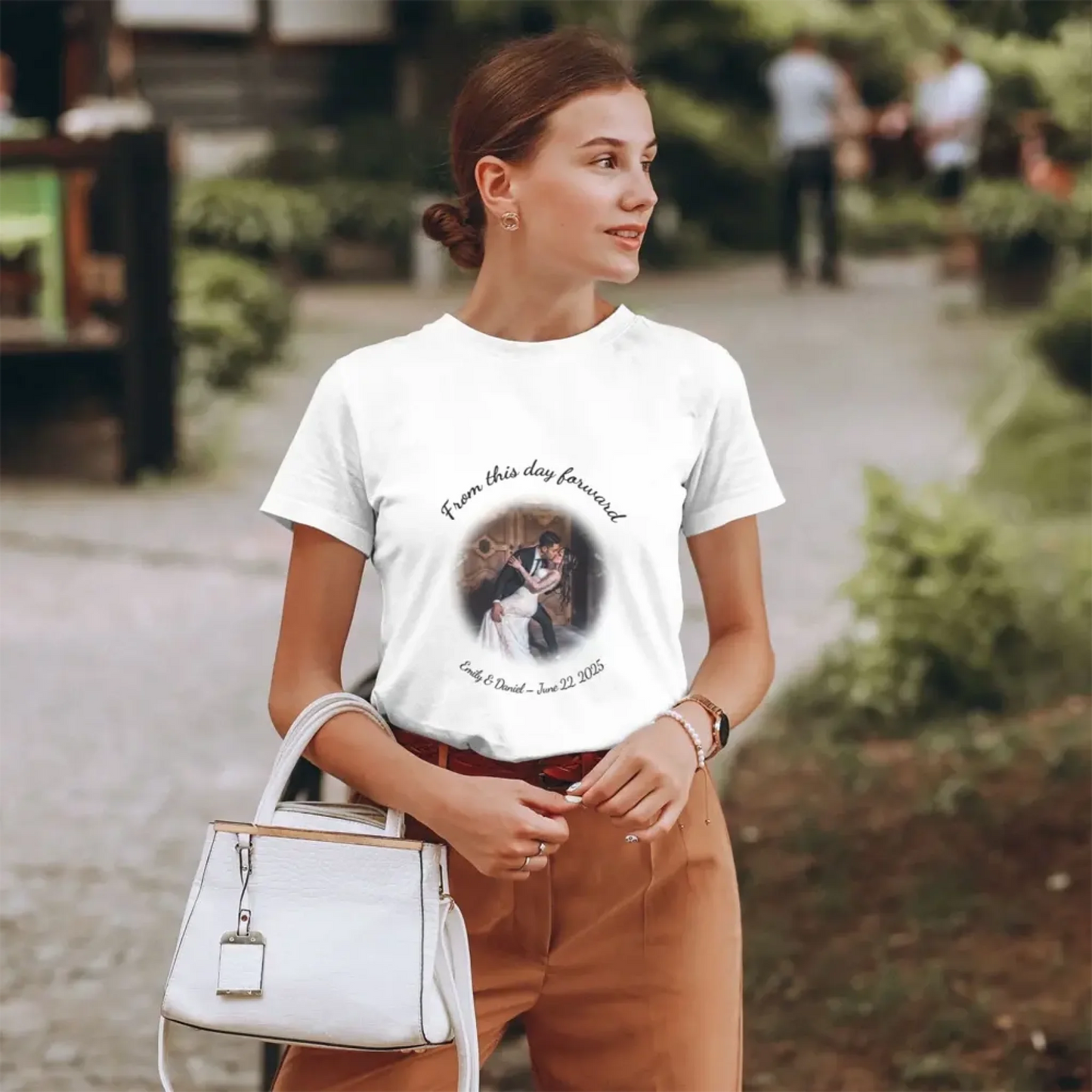 A stylish women's personalized wedding T-shirt featuring a comic-style illustration of a couple and curved custom text, best gift for anniversary, bridesmaids, or wedding guests.