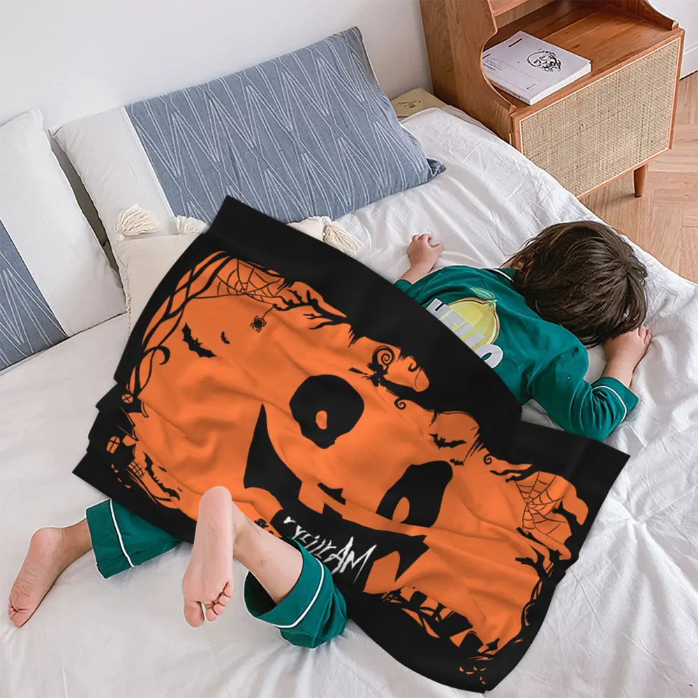Custom Halloween blanket featuring a pumpkin face design, ideal for children’s bedroom or cozy playtime.