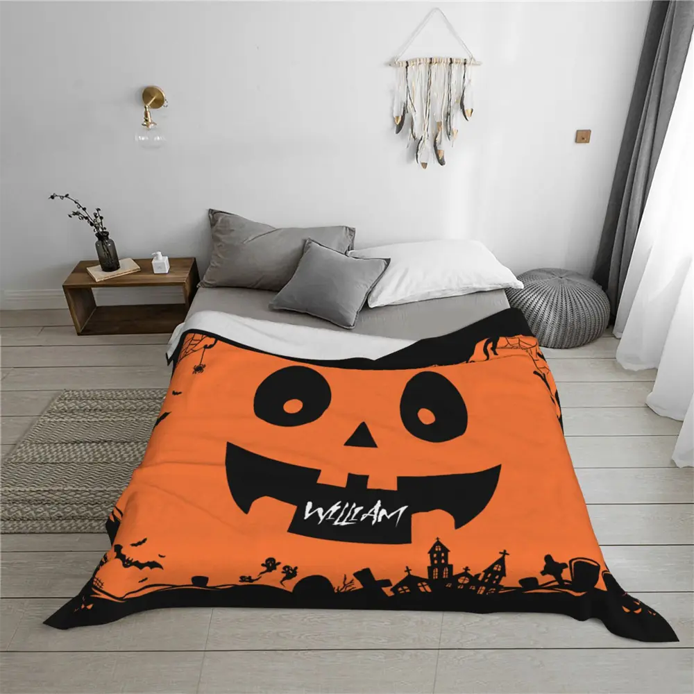 Halloween-themed personalized blanket in plush flannel, laid out on bed, perfect for festive home decoration.
