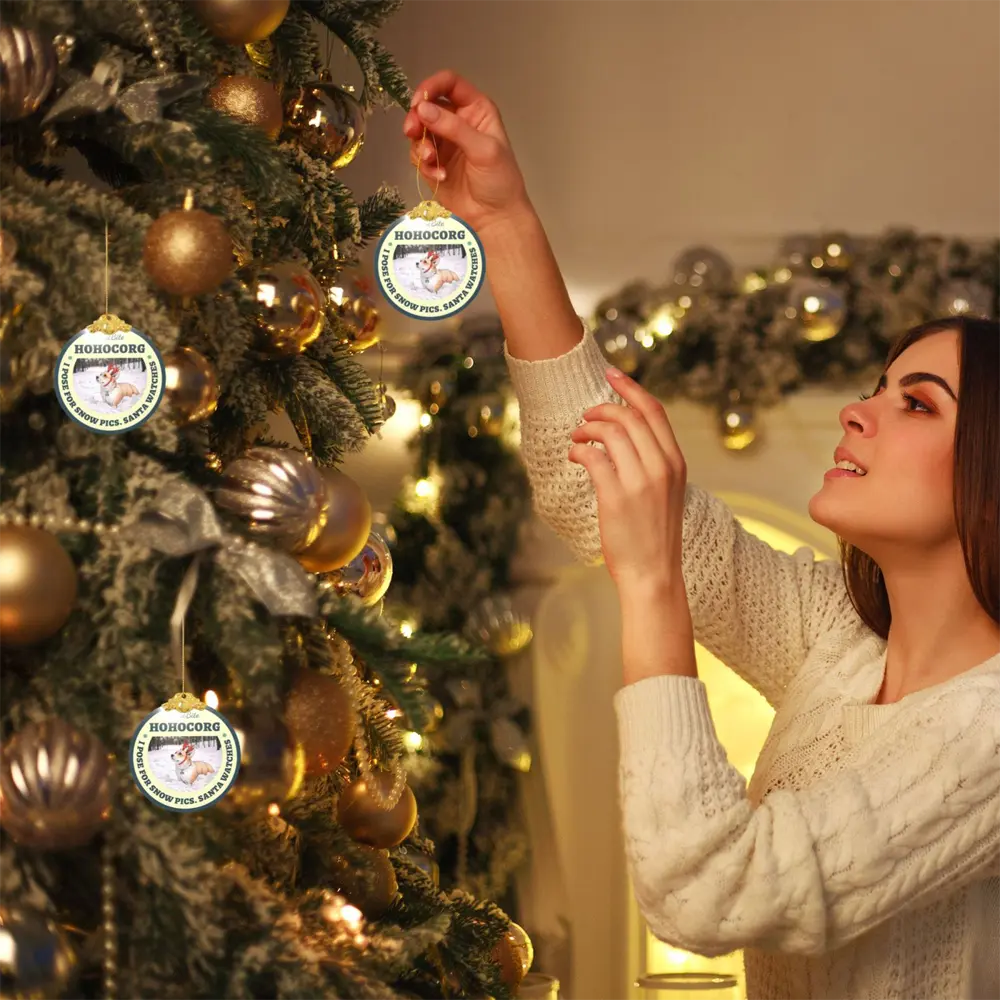 Glass Christmas ornament with photo used while decorating a Christmas tree in a warm holiday home scene