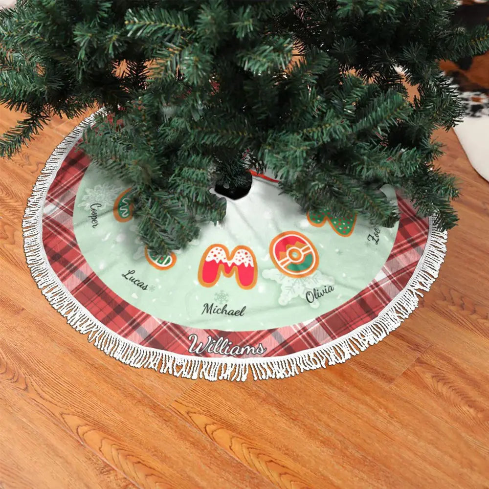 Monogrammed Christmas tree skirt with tassels, featuring classic plaid border and round center, perfect for holiday decoration.