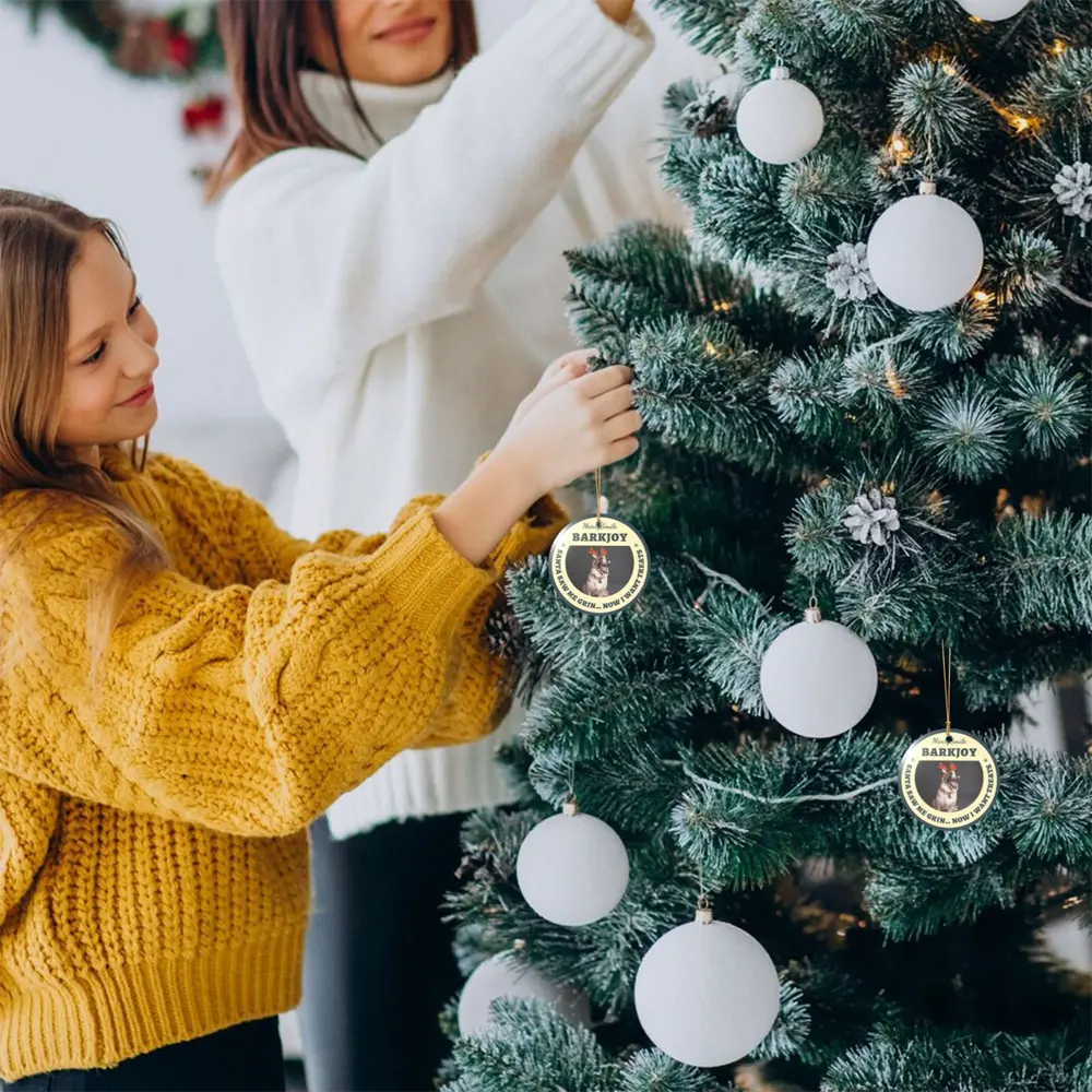 Personalized christmas ornament with photo held by a mother and child while decorating a Christmas tree together